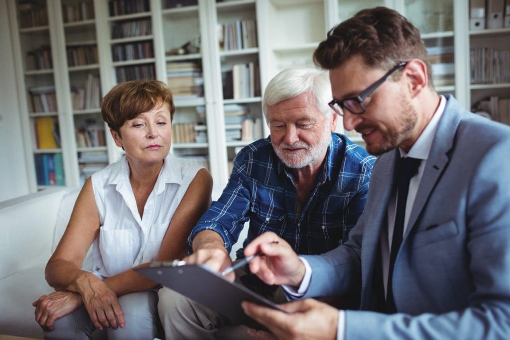 Senior couple planning their investments with financial advisor