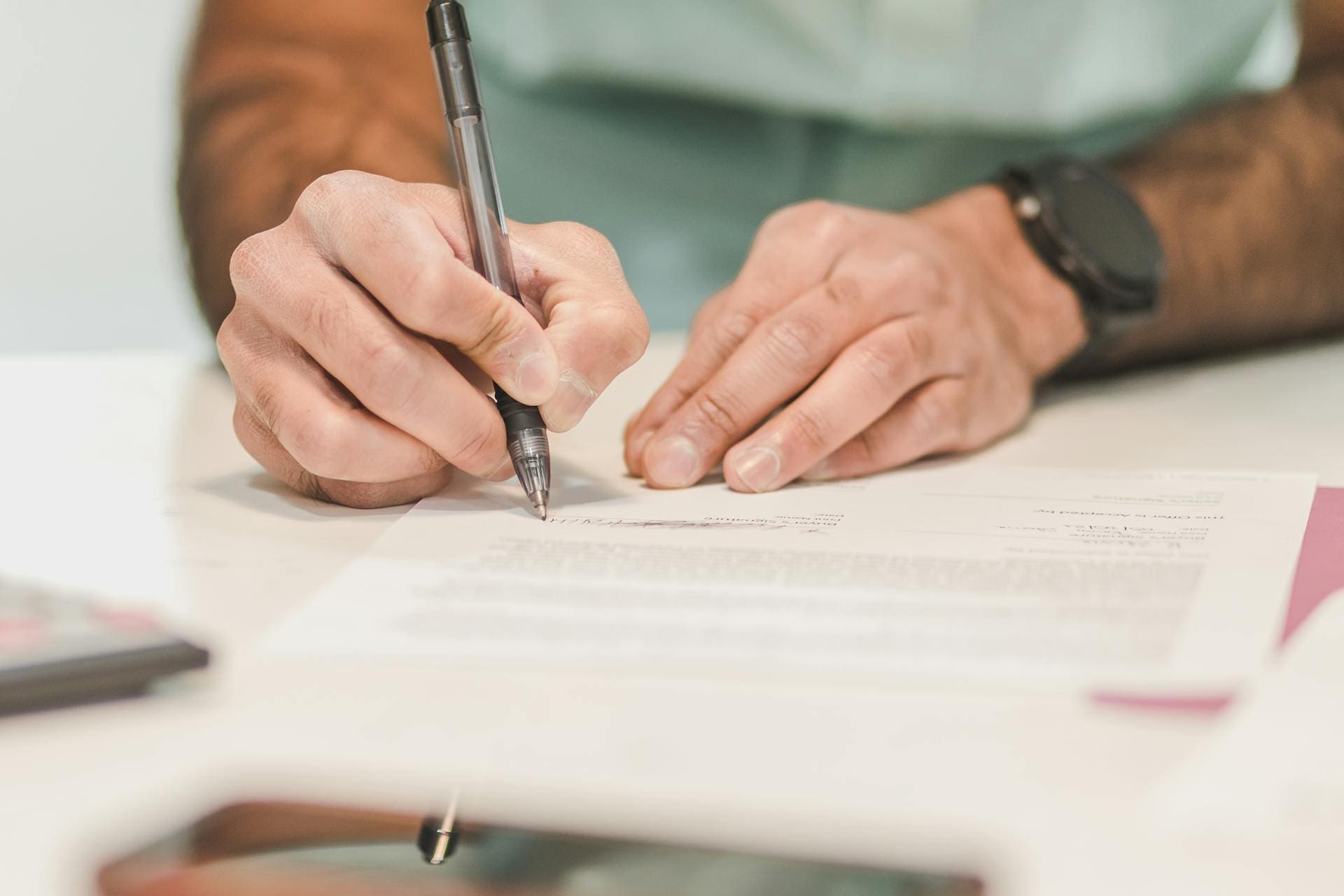 A man signing documents that a wrongful death lawyer in Reno gave him 